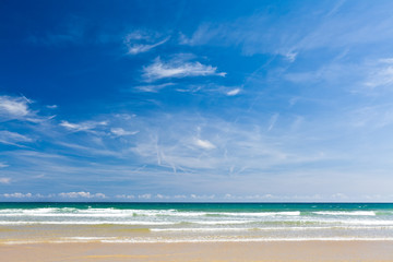 Fototapeta na wymiar Sand beach, calm sea and blue sky, copy space