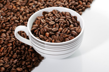 A cup of coffee beans on the edge of diagonal coffee beans shape