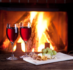 Glasses of wine, cheese and nuts.