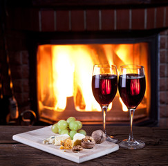 Glasses of wine, cheese and nuts.
