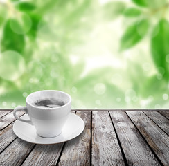 coffee on wood floor with green bokeh .