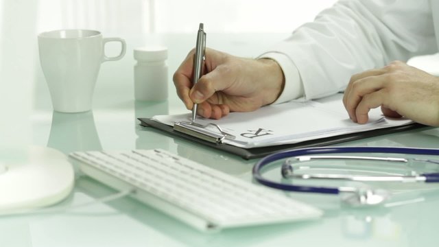 Hand doctor pen writing on rx prescription blank