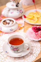 Fototapeta na wymiar Warm cup of tea and sweets