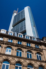 Fototapeta na wymiar Contrast of an old building and a skyscraper in Frankfurt