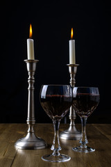 Red Wine with candles on wood table