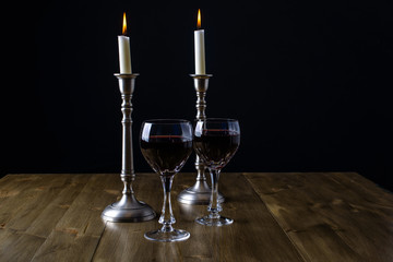 Red Wine with candles on wood table