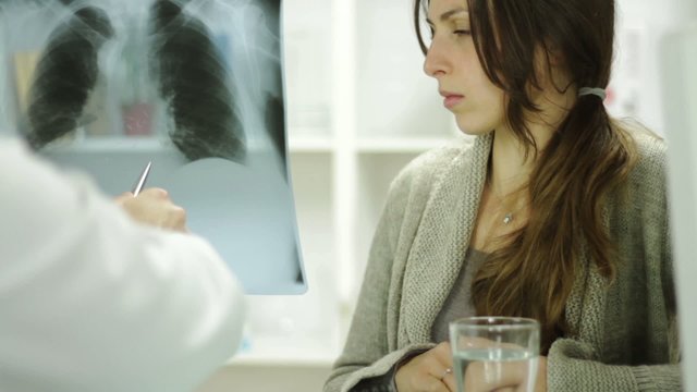 Worried Woman Looking Xray Doctor Explaining