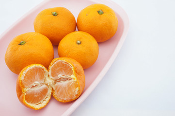 Eating orange on pink tray
