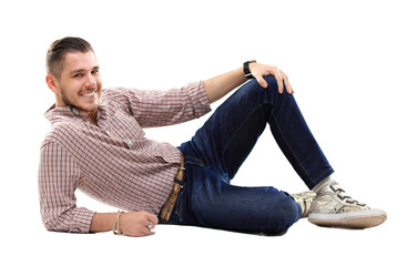 Flirtatious man sitting on the floor