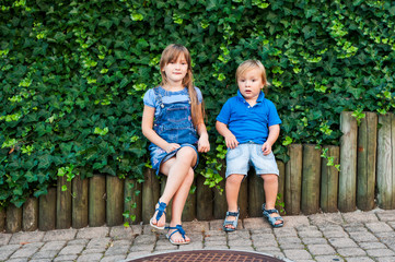 Summer portrait of a toddler brother and big sister