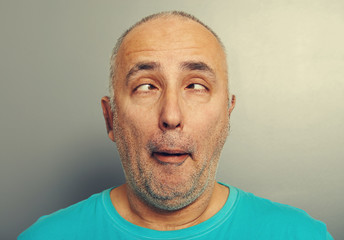 funny senior man in blue t-shirt
