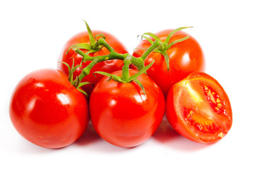 Closeup of tomatoes on the vine isolated on white. Tomato branch