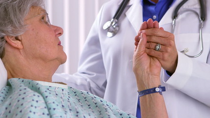 Mature patient being comforted by doctor