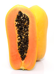 Half cut and whole papaya fruits on white background