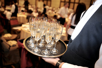 Full glasses of champagne on tray