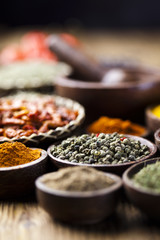 Assortment of spices in wooden bowl background 