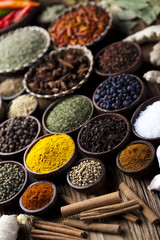 Spices on wooden bowl background 
