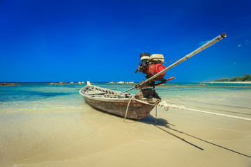 traditional long tail boat stand on the beach in Thailand