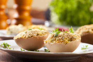 Baked eggs, stuffed with ham and parsley