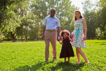Obraz premium Portrait of family - father, mother and little daughter