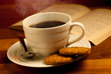 Cup of delicious black coffee on a wooden table