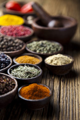 Assortment of spices in wooden bowl background 