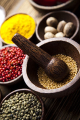 Assortment of spices in wooden bowl background 