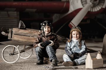 Young Aviators in aircraft in a hangar with these planes