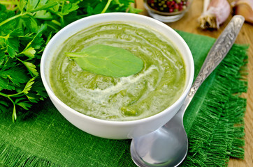 Puree green in a bowl on the board with spinach