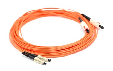 Fototapeta premium Orange optical cable on the white background macro shot.