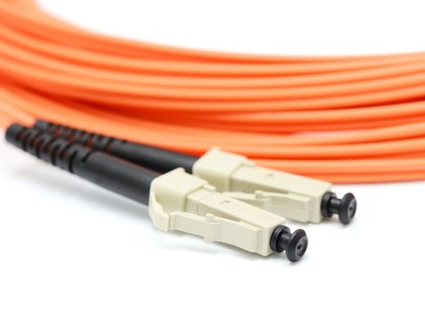 Orange optical cable on the white background macro.