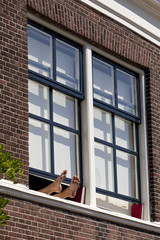 Bare feet out of the window in the sun