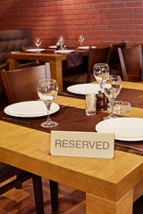 Served table with sign Reserved in restaurant