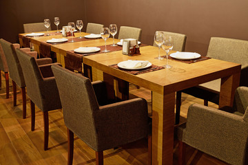Served table with armchairs around in cafe