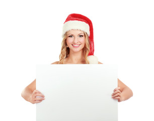Beautiful christmas woman in santa hat near empty board
