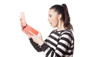 Shocked girl holding a gift in her hand