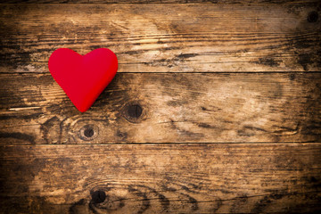 Red heart symbol on a rustic wooden planks.