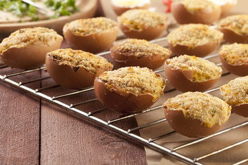 Baked eggs, stuffed with ham and parsley