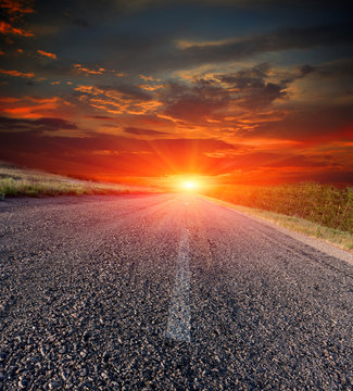 asphalt road on sunset background