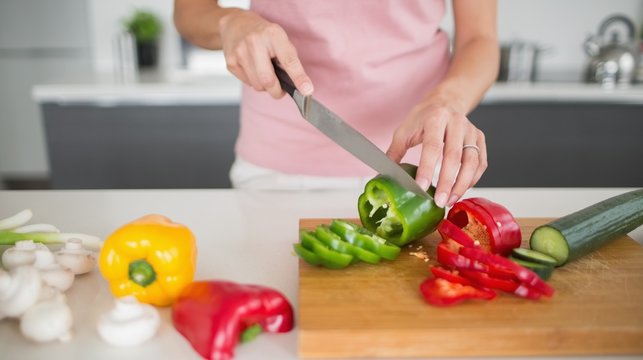Woman Chopping Vegetables - Stock Image - F003/5963 - Science Photo Library