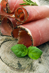 Cured ham on wooden ground