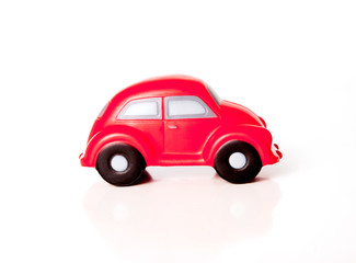 close-up of a red toy car on a white background