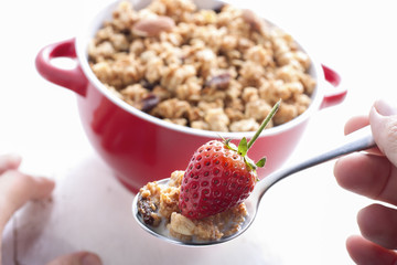 Eating muesli and fruit.