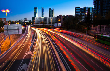 Obraz premium Blurred Tail Lights And Traffic Lights On Motorway