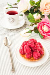 Tartlet with fresh raspberries and red tea