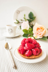Tartlet with fresh raspberries, selective focus