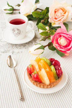 Tartlet with fresh fruits, berries and red tea