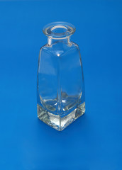 Glass vial isolated on blue background