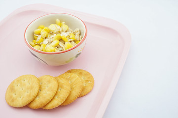 Mix corn, oats and sweetened condensed milk on pink tray