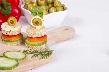 finger foods: bread, peppers, cucumber, cheese and olives